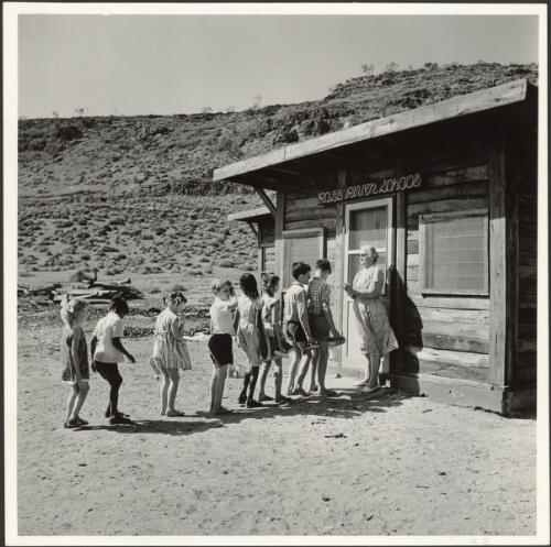 Children assemble with teacher before entering the classroom, Ross River School, east of Alice Springs, Northern Territory, 1965 [picture] / Robin V. F. Smith