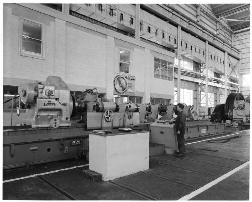 Whyalla ship building, worker standing near the gear shop, South Australia, early 1960's [picture] / Robin V. F. Smith