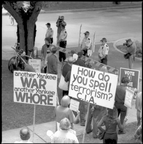 [Demonstators outside the National Press Club, Canberra, with placards reading "How do you spell terrorism? C.I.A.", "Another Yankee war another Yankee whore", 8 November 2001] [picture] / Loui Seselja