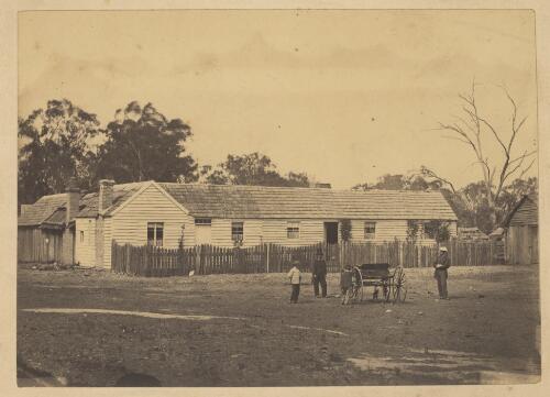 [Two men and two boys with wagonette in front of a weatherboard house] [picture]