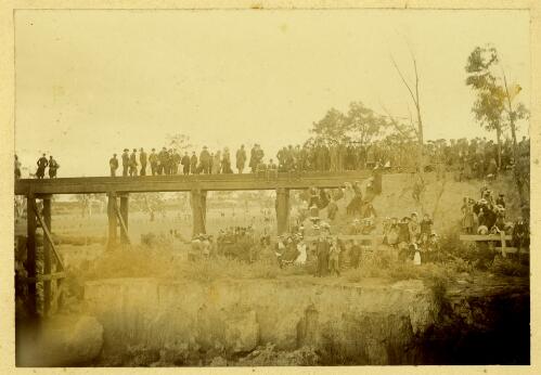 [Crowd of people standing on and around bridge] [picture]-