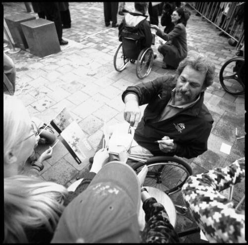 [Jim Normahas, Paralympic shooter, signs autographs for the crowd, Garema Place, Canberra, 2 November, 2000] [picture] / Louis Seselja