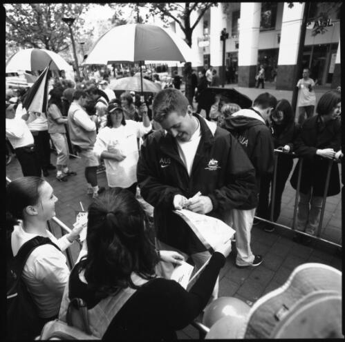[Wayne Bell, Paralympic athlete, signs autographs for the crowd, Garema Place, Canberra, 2 November, 2000] [picture] / Louis Seselja