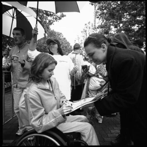 [An Australian Paralympic athlete signing autographs in Garema Place, Canberra, 2 November 2000] [picture] / Louis Seselja