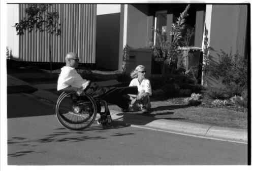 David Hall and Branka Pupovac, wheelchair tennis players,  next to a basketball residence in the Paralympic Village, Sydney 2000 Paralympic Games, 15-16 October 2000 [picture] / Jim Nomarhas