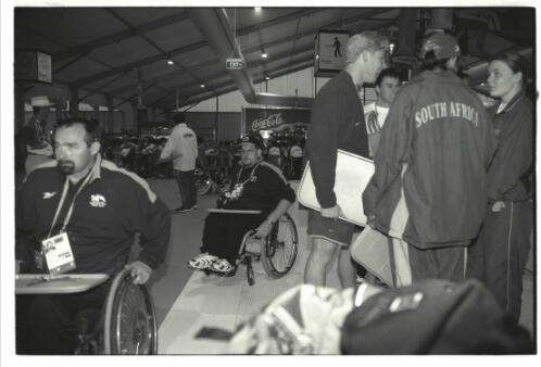 New Zealand wheelchair rifle competitor Colin Willis, mid-frame, in the dining hall in the Paralympic Village, Sydney 2000 Paralympic Games, 16 October 2000 [picture] / Jim Nomarhas