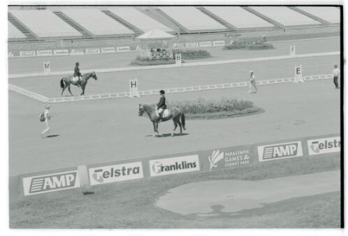 Members of the Australian equestrian team warming up and competing during the dressage competition at the Sydney International Equestrian Centre, Horsley Park, Sydney 2000 Paralympic Games, 25 October 2000 [picture] / Jim Nomarhas
