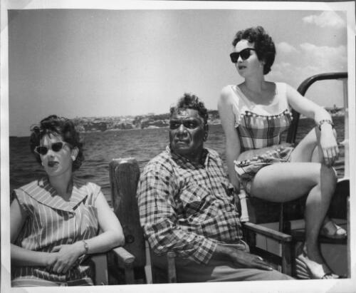 Albert Namatjira on Jack Davey's cruiser seated between two unidentified women [picture]