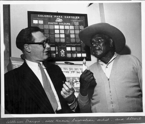 Albert Namatjira holding a tube of paint and talking to William Dargie [picture]