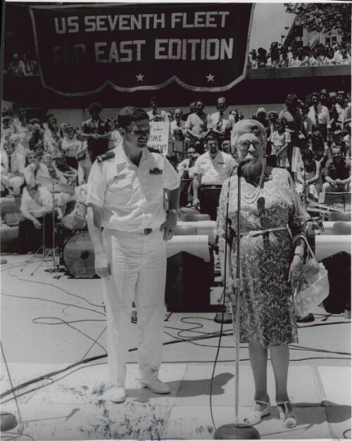 Barbara James with the conductor of 7th Fleet (U.S.) Band, Ben J. McHorney, during the Festival of Sydney, Martin Plaza, Sydney, 24 January 1979 [picture] / Ken George