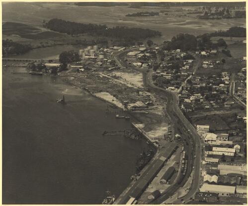 Aerial view of Devonport with the Ampol site marked with a cross, Tasmania, 1956 [picture] / Prominent Photographers