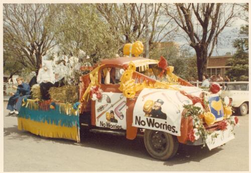 View of the Golden Fleece truck decorated for a parade with 'No Worries' signs on it at Goondiwindi, Queensland, 1974 [picture]