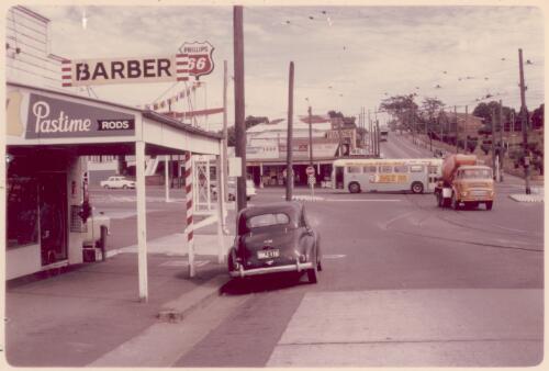 Side view of Phillips 66 service station showing a car parked on the side of the road, Annerley, Queensland [picture]