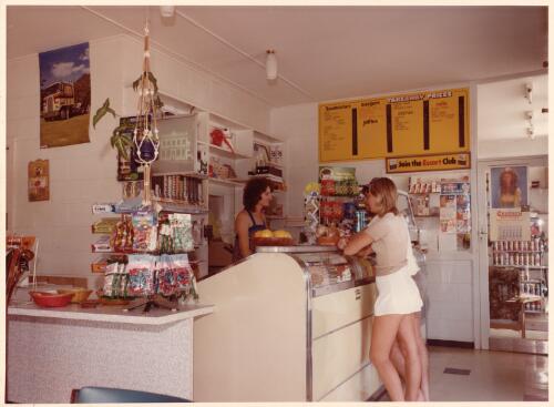 View of a waitress serving two customers at the counter of the Roselea Golden Fleece service station restaurant [picture]/ Arch Fraley