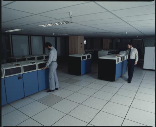 Caltex's mainframe computer room with Caltex employees using the computers [transparency]