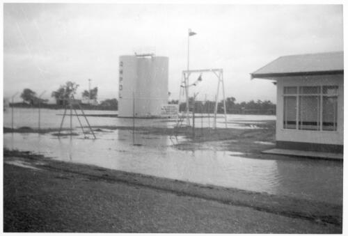 A tank and a building surrounded by water during a flood at the Bourke depot [picture]