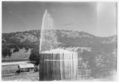 View of a firefighting equipment test being carried out on a tank at the Cootamundra Depot, March, 1954 [picture]