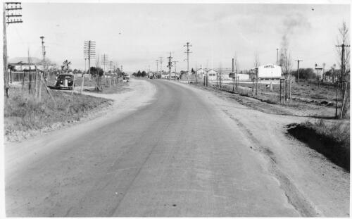 View of the Harden depot from the Yass side showing the main road into town with the triangular plot of land on the right to be used as a service station, September, 1957 [picture]