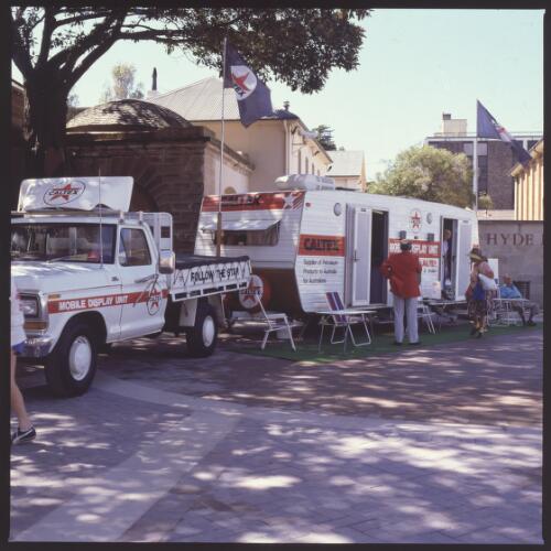 The Caltex mobile display unit consisting of a ute and caravan parked in Hyde Park during Heritage Week, Sydney, 1987 [transparency]