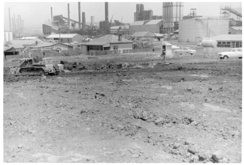 View of a bulldozer doing leveling at the Port Kembla shipping terminal during construction, December, 1959 [picture]