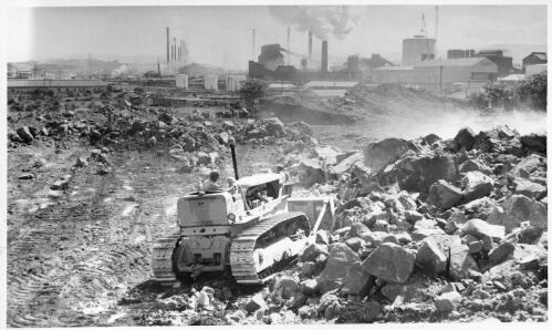 View of a bulldozer doing leveling at the site for storage tanks at the Port Kembla shipping terminal during construction, October, 1958 [picture]