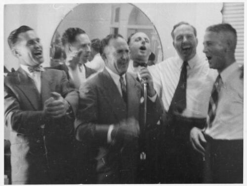 The South Australian representatives, Ron Jensen, J. Langford, G. Hasenkam, A. Hollings, K.B. Alford and J. Falahey, render an item of entertainment after the final dinner of the Ampol Australian exeuctives conference, Leaura, N.S.W., January, 1956 [picture]