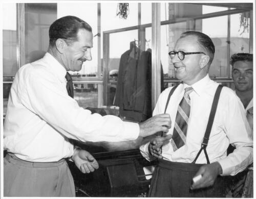 Mr. R.W. Saunders, Manager, presents D. Sawtell, Termianl Superintendent, with his ten year pin at the staff Christmas party, Birkenhead shipping terminal office, December, 1956 [picture]
