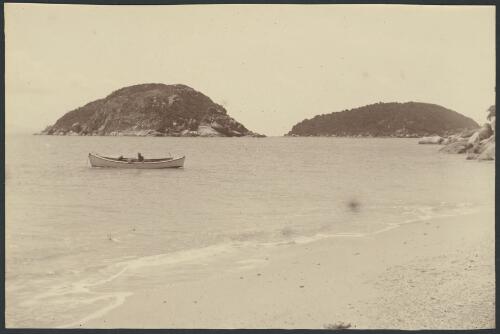 Unidentified man in a boat with part of the Family Isles in the background [picture] / Archibald James Campbell