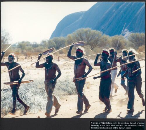 A group of Pitjantjatjara men demonstrate the art of spear throwing; some have a woomera in place which increases the range and accuracy of the thrown spear [picture] / prepared by Media and Communications, Department of Aboriginal Affairs