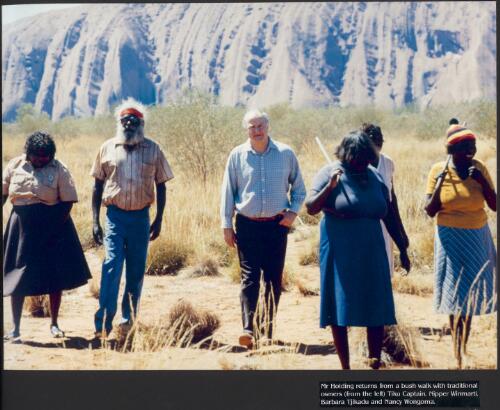 Mr. Holding returns from a bush walk with traditional owners (from left) Tiku Captain, Nipper Winmarti, Barbara Tjirkadu and Nancy Wongoma [picture] / prepared by Media and Communications, Department of Aboriginal Affairs