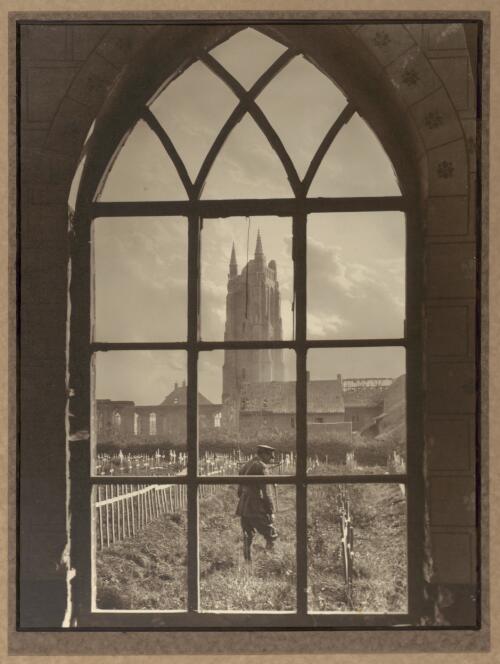 Looking through a ruined cathedral window on to a battlefield cemetery [picture] / Capt. Frank Hurley