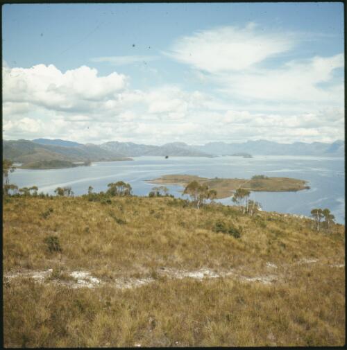 Lake Pedder partly filled, looking from grassy high land down to island, Tasmania, ca. 1974 [transparency] / Russ Ashton