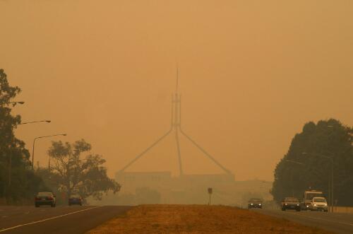 Parliament House looms out of the smoke haze from the Canberra bushfires, 20 January 2003 [picture] / Tony Miller