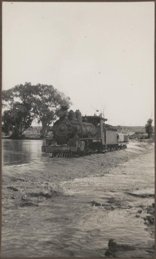 Engine crossing Finke River in flood, Northern Territory, 1939 [picture] / Clarence Bernhardt