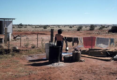 Francesca Ronson Briscoe (wife of John Briscoe) washing clothes at Finke, Northern Territory 1976 [picture] / Johnny Briscoe