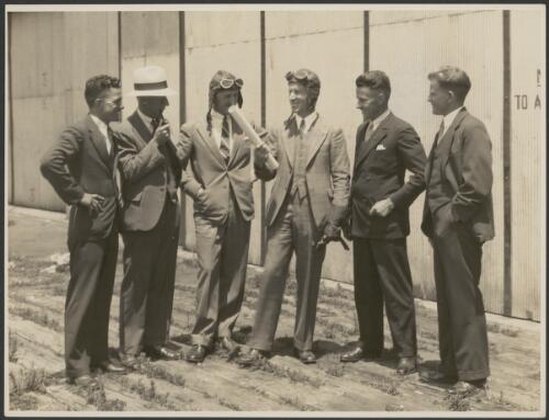 Group portrait of T. Pethybridge, W. Kingsford Smith, P.G. Taylor, C.E. Kingsford Smith, John Stannage, H. Affleck, Mascot Aerodrome, Sydney, 1934 [picture]