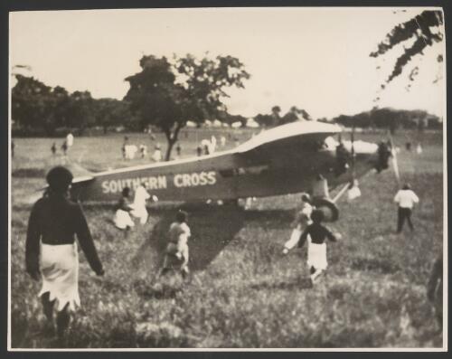 The Southern Cross, a Fokker F.VII/3m monoplane, VH-USU being greeted by Fijians, Albert Park, Suva, 5 June, 1928 [picture] / Associated Newspapers