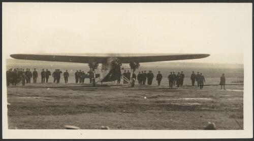 Police escort beside the Southern Cross, a Fokker F.VII/3m monoplane, VH-USU as it lands at end of first trans-Pacific flight, Mascot Aerodrome, Sydney, 10 June 1928 [picture] / Sun Feature Bureau