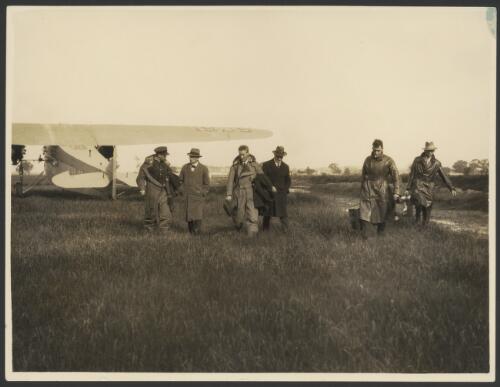 Charles Ulm, Charles Kingsford Smith, H.A. Litchfield, T.H. McWilliam after landing the Southern Cross, Fokker monoplane F.VII/3m, VH-USU, with two unidentified men, 1920s [picture] / West Australian Newspapers