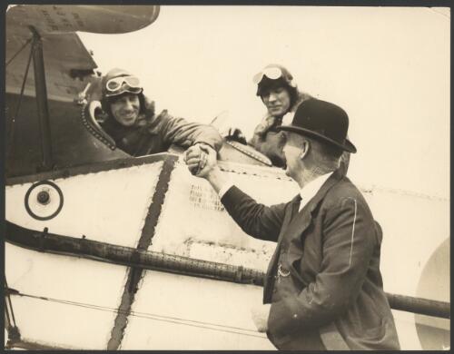Charles Kingsford Smith and Charles Ulm in cockpit of Bristol Tourer biplane, being met on arrival by Mayor George Baildon at Auckland, New Zealand, September 1928 [picture] / Auckland Sun