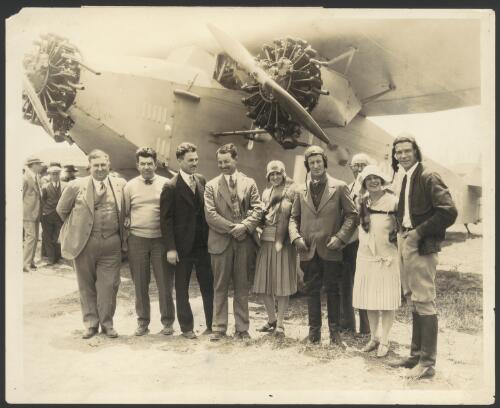 Harry Lyon, James Warner, Charles Kingsford Smith and Charles Ulm in front of the Southern Cross, Fokker monoplane VH-USU with three friends, before take-off for Oakland from Los Angeles, California, United States, 23 May 1928 [picture] / H.B. Miller