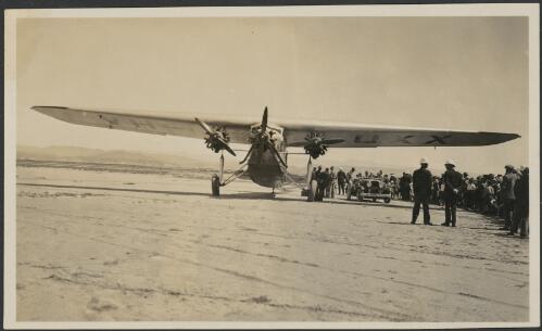Faith in Australia, Avro X monoplane VH-UXX next to a car and crowd of onlookers at Muriwai Beach, Auckland, New Zealand, 17 February 1934 [picture]