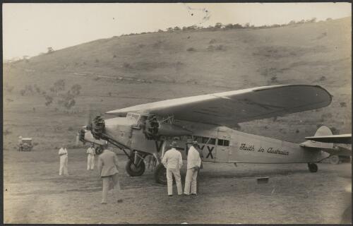 Six unidentified men observing Faith in Australia, Avro X monoplane VH-UXX, Port Moresby, 26 July 1934 [picture]