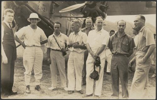 Charles Ulm and Scotty Allan with journalists and officials in front of Faith in Australia, Avro X monoplane VH-UXX, on completion of first official Australia - Papua-New Guinea airmail flight, Port Moresby, 26 July 1934 [2] [picture]