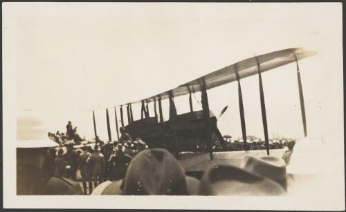 Biplane surrounded by onlookers, ca. 1928 [picture]
