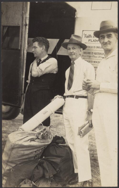 Portrait of Charles Ulm, E. Imlay and L. Drewe with mail bags in front of Faith in Australia plane VH-UXX, Port Moresby, Papua New Guinea, 26 July 1934 [picture]