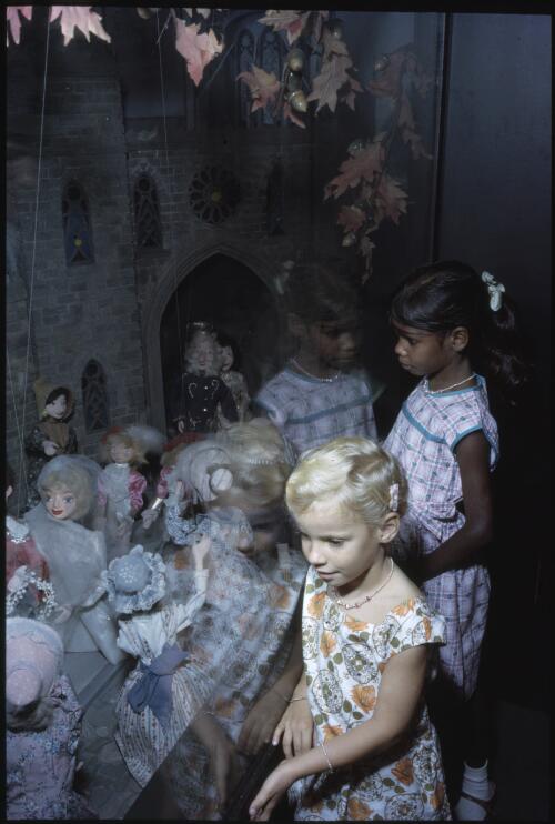 Fitzroy Crossing Missionary's daughter and friend examine Christmas display, Perth, West Australia 1966 [transparency] / Robin Smith