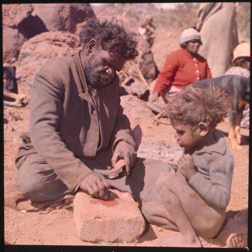 Fashioning a woomera, Central Australia 1966 [transparency] / Robin Smith