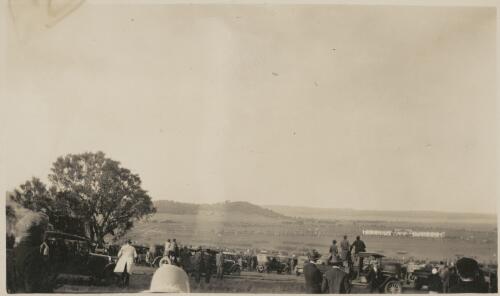Spectators watch the troop formations on the parade ground outside Parliament House, Canberra, Australian Capital Territory, 9th May 1927 [picture] / May Sibley