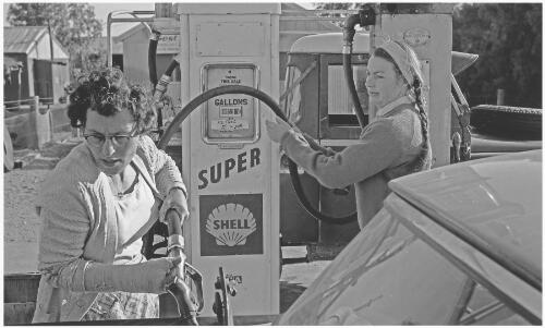 Co-owner Dawn Severin fuelling a tourist vehicle at Curtin Springs, Northern Territory,1968 [picture] / Jeff Carter